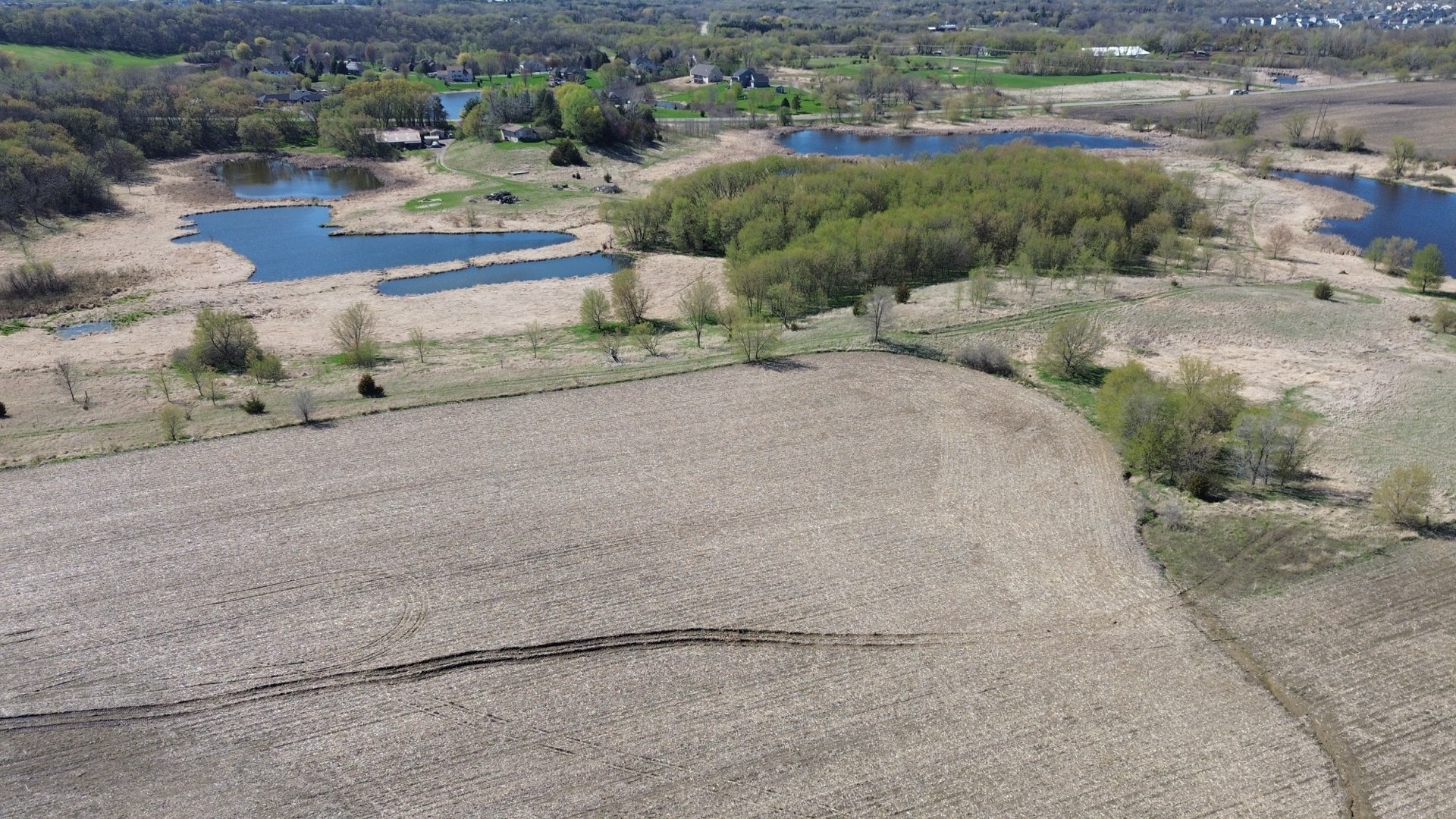 Aerial view of Legacy Woods showing ponds, open land, and surrounding property